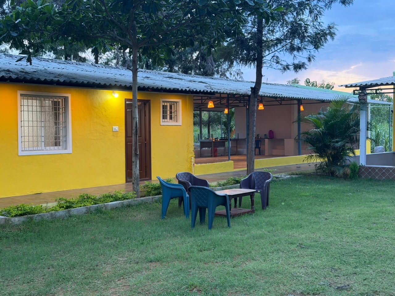 The Yellow House Farmstay exterior at dusk